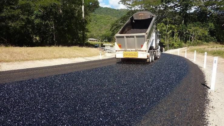 Truck delivering hot mix on a rural road