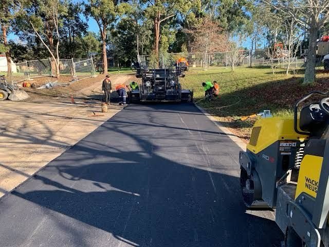 Paving crew laying asphalt with a paver